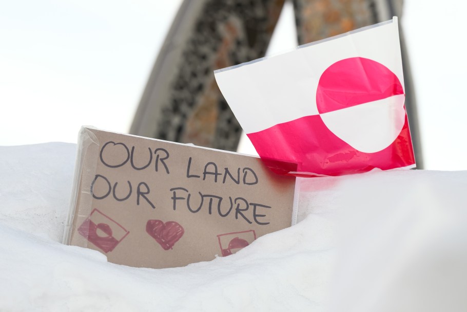 NUUK, GREENLAND - MARCH 30: A sign reading "Our Land Our Future" rests in the snow alongside the flag of Greenland,  on March 30, 2025 in Nuuk, Greenland. A visit this week to Greenland by a US delegation - including Vice President JD Vance, his wife and other officials - has provoked angry reactions from politicians here and in Denmark, which governs the foreign and defense policies of the semiautonomous island. The American delegation's visit follows vows by US President Donald Trump to gain control of Greenland "one way or the other," citing its strategic importance to the US. (Photo by Leon Neal/Getty Images)