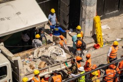 Personnel from civil defense and firefighters work at the Jet Set nightclub following the collapse of its roof in Santo Domingo on April 8, 2025. Rescuers raced to find survivors Tuesday among the rubble of a Dominican Republic night club where at least 44 people died and dozens were hurt in an early-morning roof collapse. (Photo by Francesco SPOTORNO / AFP) (Photo by FRANCESCO SPOTORNO/AFP via Getty Images)
