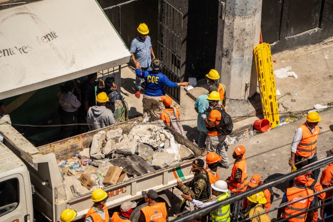 Personnel from civil defense and firefighters work at the Jet Set nightclub following the collapse of its roof in Santo Domingo on April 8, 2025. Rescuers raced to find survivors Tuesday among the rubble of a Dominican Republic night club where at least 44 people died and dozens were hurt in an early-morning roof collapse. (Photo by Francesco SPOTORNO / AFP) (Photo by FRANCESCO SPOTORNO/AFP via Getty Images)